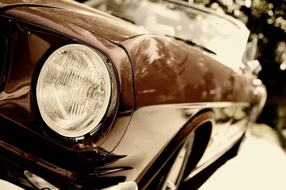 Appraiser examining a vintage muscle car in a collector garage