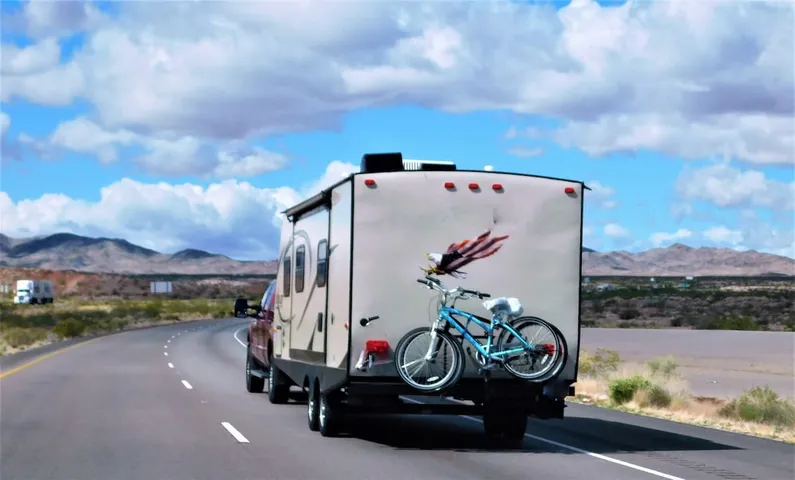 Appraiser inspecting a recreational vehicle at a campsite